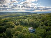 Once part of George Inness Jr&rsquo;s iconic 350-acre Chetolah estate. This 5 bedroom, 2.5 bath historic Cragsmoor home includes 3 lots totaling over 34 acres of pristine land with a mix of woodlands, original trails, meadow, pond, stream, expansive views and bordering the 5000-acre Sam&rsquo;s Point preserve for easy hiking enjoyment. An additional cabin is located to the east of the house that has tremendous potential as a guest house or studio once restored. Steeped in deep nature and history, the home was named Breezy Brow and built for Inness&rsquo;s daughter and maintains many of the original circa 1901 details; coffered ceilings, rich woodwork, 2 fireplaces and multiple covered porches to enjoy the views and nature. Special pigments have been used for the interior of the home. The quaint mountaintop community of Cragsmoor is home to many lovely historic homes, but very few have the level of privacy and lot size this property offers, coupled with adjacent preserve lands to ensure its ongoing serenity and beauty. The additional lots could be very scenic sites for other homes. One hour and 22-minute drive to the GW bridge makes this a comfortable weekend escape.