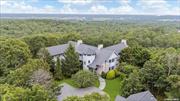 The Most Architecturally Remarkable Residence in Water Mill.  6+ Acres, 950 SF Infinity Pool, Movie Theater, and more. Available for the First Time Ever. Lively and luxurious, this stunning 6-bedroom, 8.5-bathroom masterpiece spans nearly 12, 000 square feet. Conceptual work was done by AD recognized designer Greg Jordan, while renowned interior designer Sasha Bikoff reimagined many of the home&rsquo;s individual rooms and spaces.  This exceptional property sits at the end of a long, wooded path with a remote-controlled entry gate for added privacy. A grand two-story house comes into view, featuring sand-blasted Cypress siding, simulated slate shingles, and an enchanting turret surrounded by lush landscaping and foliage. The grounds feature a quartzite stone patio, verdant lawn space, and a stunning infinity pool with serene countryside views. There is more than enough room for a tennis court, and the detached garage has an alarm system and can accommodate up to 5 cars.  Interiors of the home are spacious, colorful, and bright. English brown oak floors complement custom built-ins, exposed beams, crown molding, and bay windows. The HVAC system includes environmentally friendly coolant, 13 remote-controlled temperature zones, 240 gallons of indirect hot water heaters, and 4 hot water boilers that produce 1 million BTUs of heat. Power comes from 10 sub-panels with 800 Amps supply, and all areas are wired with Fiber and Cat-5/6 cabling. The home has four staircases in total-two leading to the upper-level wings and two leading to the lower-level wings.  On the FIRST LEVEL, residents are greeted by a grand foyer and spiral staircase with a gleaming chandelier and soaring 32-foot ceilings. Beyond the foyer is a sun-splashed great room with 30-foot ceilings, multiple access points to the outside areas, and a double-sided wood-burning fireplace with a floor-to-ceiling stone surround that connects to a tranquil library. The formal dining room has a fireplace and swinging doors leading to a windowed butler&rsquo;s pantry perfect for prep work and storage. The kitchen has its own fireplace, two sinks, and high-end stainless steel appliances. There is also a quiet bedroom wing with a windowed kitchenette and a pair of en-suite bedrooms with access to a private deck. The SECOND LEVEL has three bedrooms with en-suite bathrooms, walk-in closets, and private outdoor balconies. The primary suite occupies its own wing and has his-and-hers offices and closets and a private balcony with views stretching to the ocean on a clear day. There is also a windowed kitchenette perfect for enjoying morning or evening beverages and snacks.  On the LOWER LEVEL, a central hall connects two separate wings. An en-suite bedroom, laundry room, mudroom, full bathroom, and private gym occupy one wing, while the other features a dazzling theater-style media room, game room, and cinema with playful design features, a full bathroom, and access to the outdoors. Whimsical pendant lighting adorns a marble wet bar with a fridge, ice maker, and sink. A pool table anchors the space, and vivid seating and carpeting create a truly unique space. The cinema was optimized for sound by an acoustic designer.