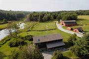 Introducing Walking Valley Farms! This one&rsquo;s for all of those whose Upstate dreams center on horses and open pastures. The beautiful three bedroom home shares its 25+ acres with an 12 stall horse barn (with 800 square foot home gym on the second level), four fenced paddocks, a plethora of outbuildings and an arena waiting to be brought back to life. Entering this gated property, you&rsquo;ll turn first into the driveway to the main house. A charming rocking chair front porch beckons you to the main entrance. Through the front door, you&rsquo;ll enter the incredibly spacious and sunny living room, with ample room to relax and entertain. Just to your left will a be a guideway to the cozy dining area and then onto the large L-shaped kitchen, complete with ample cherry cabinets and granite countertops. Appliances include range and hood, refrigerator, microwave drawer and beverage fridge. Radiating off this space are a large mudroom, convenient home office, full bath with washer/dryer, and an incredibly cozy and charming sunroom. Up the the open modern staircase, you&rsquo;ll find a large landing that currently houses a comfortable home library and reading nook. To one side, you&rsquo;ll find the generous primary bedroom suite, with sweeping views of the back fields and neighboring wetlands. The luxurious bath includes walk-in shower, jetted soaking tub and Carrera marble dual vanities. Finishing off this space are his-and-hers walk-in closets. On the other side of the house are two are two spacious and sunny additional bedroom and a third full bath.The walk-out basement is currently unfinished, but does have insulation and two fuel sources (propane and pellet), so if you ever needed more space, there&rsquo;s room to expand. A spacious wraparound deck completes the main house. Outside, the first of many outbuildings is an office/man-cave with heat and insulation that is able to be used year-round. The roof of this building also is home to a unique fountain which feeds the 5, 000 gallon koi pond. Next is a large shed for storing all your gardening tools. Next up is the 12-stall horse barn, including a complete washing stall and with new roof as of 2023. Upstairs in the loft is a finished space currently housing a complete home gym. The grounds also offer four fenced in paddocks (two with lean-tos), a former arena, pigeon cote, and an additional storage barn. Multiple sitting and gardening areas are dotted throughout the property and it borders a scenic wetland which supplies the nesting bald eagle pair with plenty of food and you with plenty of views. Situated in Bethel, NY, the current owners enjoy riding their bikes to concerts at Bethel Woods. Lake Superior Park is just a short drive away. Walking Valley Farms is also convenient to the Homestead School and the restaurants and attractions of the lakeside hamlet of Kaneunga Lake. Additional Information: Amenities:Marble Bath, Appliances: Electric Water Heater ConstructionDescription: Wood Siding,