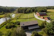 Introducing Walking Valley Farms! This one&rsquo;s for all of those whose Upstate dreams center on horses and open pastures. The beautiful three bedroom home shares its 25+ acres with an 12 stall horse barn (with 800 square foot home gym on the second level), four fenced paddocks, a plethora of outbuildings and an arena waiting to be brought back to life. Entering this gated property, you&rsquo;ll turn first into the driveway to the main house. A charming rocking chair front porch beckons you to the main entrance. Through the front door, you&rsquo;ll enter the incredibly spacious and sunny living room, with ample room to relax and entertain. Just to your left will a be a guideway to the cozy dining area and then onto the large L-shaped kitchen, complete with ample cherry cabinets and granite countertops. Appliances include range and hood, refrigerator, microwave drawer and beverage fridge. Radiating off this space are a large mudroom, convenient home office, full bath with washer/dryer, and an incredibly cozy and charming sunroom. Up the the open modern staircase, you&rsquo;ll find a large landing that currently houses a comfortable home library and reading nook. To one side, you&rsquo;ll find the generous primary bedroom suite, with sweeping views of the back fields and neighboring wetlands. The luxurious bath includes walk-in shower, jetted soaking tub and Carrera marble dual vanities. Finishing off this space are his-and-hers walk-in closets. On the other side of the house are two are two spacious and sunny additional bedroom and a third full bath.The walk-out basement is currently unfinished, but does have insulation and two fuel sources (propane and pellet), so if you ever needed more space, there&rsquo;s room to expand. A spacious wraparound deck completes the main house. Outside, the first of many outbuildings is an office/man-cave with heat and insulation that is able to be used year-round. The roof of this building also is home to a unique fountain which feeds the 5, 000 gallon koi pond. Next is a large shed for storing all your gardening tools. Next up is the 12-stall horse barn, including a complete washing stall and with new roof as of 2023. Upstairs in the loft is a finished space currently housing a complete home gym. The grounds also offer four fenced in paddocks (two with lean-tos), a former arena, pigeon cote, and an additional storage barn. Multiple sitting and gardening areas are dotted throughout the property and it borders a scenic wetland which supplies the nesting bald eagle pair with plenty of food and you with plenty of views. Situated in Bethel, NY, the current owners enjoy riding their bikes to concerts at Bethel Woods. Lake Superior Park is just a short drive away. Walking Valley Farms is also convenient to the Homestead School and the restaurants and attractions of the lakeside hamlet of Kaneunga Lake.