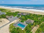 Discover an unparalleled oceanfront summer retreat in the highly sought-after village of Quogue. Nestled directly on the dunes, this rare property offers an extraordinary experience with unmatched proximity to the gentle rolling waves and pristine white sands of your private beach. Enjoy unparalleled privacy and breathtaking sunrises that greet guests of all ages each morning. Situated on approximately 2.3 acres of prime oceanfront real estate, this estate boasts an impressive 231 feet of private beach frontage, providing direct access to the Atlantic&rsquo;s pristine sands and waters. The main house, a centerpiece of this stunning property, features four bedrooms and three and a half bathrooms and is perfectly positioned within the dunes. Renovated by renowned builder George Vickers, this multi-building compound exemplifies vintage Quogue charm, blending timeless elegance with luxurious indoor-outdoor living. Each structure has been meticulously designed and custom-built to create an exclusive oceanfront haven. The main residence includes an oversized professional chef&rsquo;s kitchen, outfitted with a Wolf 8-burner range and double ovens, a full-size side-by-side refrigerator and freezer, and a wine cooler. A sprawling center island serves as both a practical workspace and a social hub for family and friends. The open-concept living area, featuring soaring ceilings, exposed beams, and a wood-burning fireplace, offers a cozy and inviting space for relaxation after a day at the beach. Additionally, the property includes a charming two-bedroom guest cottage with its own kitchen and wet bar, providing a private retreat for guests. Adjacent to the cottage, a sun-drenched 20x40 heated gunite pool is surrounded by an expansive wraparound deck, ideal for swimming or sunbathing. Conveniently located just minutes from Quogue Village and the shopping and dining on Westhampton Beach Main Street, this property delivers a truly magical, one-of-a-kind oceanfront experience in the Hamptons. For those seeking an extraordinary coastal retreat situated directly on the dunes and mere feet from the majestic breaking waves, this is the ultimate destination.