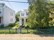 In the heart of Historic Hudson, this Victorian Italianate sits on a generous double lot and awaits your vision and restoration. One of the most unique properties available in all of Hudson is being offered for the first time in half a century. With its historic charm and detail still intact, the space could be reimagined contemporary, or brought back to its original grandeur featuring a dramatic staircase, 8 ft tall French windows, built-in cabinetry, and more. The grounds showcase a picket fence, perennial gardens and dual ingress from Union & Partition St. The lot offers accessibility for parking, patio build-out, gardens, or garage. Enjoyable outdoor spaces that feature a covered wrap-around porch protected by shade of a mature cedar tree and an enclosed, heated four seasons sunroom. Originally built as a two-family, the west stairway is usable or could be removed to expand the primary kitchen. Put your stamp on a remarkable property in Upstates most popular destination. Centrally located and walkable (Amtrak, restaurants, theatres, galleries, parks and shops).