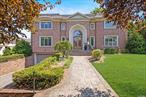 Welcome to this picture-perfect 7-bedroom, 6.5-bathroom brick center hall colonial, offering 5, 200 square feet of refined living space in the highly sought-after Village of Saddle Rock. As you enter the dramatic double-height foyer, you are greeted by a stunning wrought iron circular staircase and an open floor plan that exudes elegance. The home features soaring 10-foot ceilings and a modern eat-in kitchen, complete with a large center island and breakfast area, perfect for casual dining and entertaining. Host elegant gatherings in the grand dining room with radiant heat or relax in the expansive living room, designed for seamless entertaining. A cozy den with a fireplace adds a touch of warmth, while a first-floor laundry room and a versatile bedroom or office with an en suite full bath provides convenience and flexibility. Architectural moldings, hardwood floors, luxurious marble, onyx bathrooms and a generator highlight the home&rsquo;s attention to detail. The expansive finished walk-out lower level, with its soaring ceilings, offers a bedroom, full bath, playroom and ample storage, making it an ideal space for recreation and organization. Outside, enjoy the proximity to Saddle Rock Village Park, featuring a private marina, waterfront pool, tennis courts, and basketball courts. This residence is not just a home; it&rsquo;s a lifestyle, perfectly suited for easy living and exceptional entertaining.