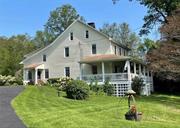 Step back in time to experience the antique charm & character of this circa 1769 colonial farmhouse with 2648 sq. ft. of elegant living space, that has been lovingly refreshed, restored and enhanced with modern upgrades, amenities & improvements, while preserving many of the early features, set back on 2.5 parklike, beautifully landscaped acres with a 2 car detached, board & batten sided garage (that can accommodate a truck) and barn. It features original wide plank floors, some early woodwork & doors, 5 fireplaces with original mantles ( Only two are working with woodstove inserts ) & designer, eat in kitchen with custom cherry cabinetry & soapstone counters that opens to a delightful family room, a dining room now used as an office & a wonderful living room and a full bath with shower & laundry room on the first level. Upstairs is a huge bedroom, now used as a craft/sewing room, that could be reconverted back to a 2 bedroom, with additional bedrooms and full bath with claw foot tub and shower. There is a walk up attic. You will adore the 100 x 12&rsquo; three sided wrap around front porch to enjoy the sunrises, the sounds of birds, sip your morning coffee or tea, or just relax & unwind from life&rsquo;s stress, surrounded by the beauty of nature or play on your expansive front porch & side yard. If is so peaceful yet you are close to village shopping in Walden, Pine Bush & Montgomery with great restaurants, parks Wallkill River, golf courses, City Winery, Angry Orchard. A heavenly haven awaits you.