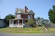 TOTALLY TURNKEY â€“ See the best of the past and present in this stunning, one of a kind, FULLY RESTORED 1880 Queen Anne Victorian! Solid and stately, this beauty has been renovated with modern amenities while retaining its original details and character. The brick exterior charms together with intricate woodwork, a grand WRAP-AROUND PORCH with ornate columns, and colorful STAINED-GLASS windows.As you cross the threshold, the foyer greets you with a modern chandelier casting a warm glow over the ORIGINAL WOOD FLOORING and majestic staircase. This area seamlessly transitions into a BRAND-NEW GOURMET KITCHEN...making a delight for all of your culinary adventures. It is complete with Energy Star Stainless Steel Appliances, Sleek Quartz Counter Tops, high end KRAFTMAID Soft Close Cabinetry and an Enormous Island with BREAKFAST BAR! There is also room for a cozy, duo dining table as well.The living room beckons with its WOOD BURNING FIREPLACE and decorative bay window. This home has been fitted with NEW PELLA WINDOWS, has been completely FRESHLY PAINTED, all the floors refinished, and new insulation to boot. As you explore the nooks and crannies on the first floor, you will discover a dining room, pantry, and a NEW HALF BATH, too!Ascend up the stairs to the second floor to find three roomy bedrooms, a new luxurious bathroom with a WHIRLPOOL TUB, and the convenience of having a laundry room on this level. The walk-up attic is massive with its high ceilings and large windows that usher in lots of NATURAL LIGHT...this could be an amazing ARTIST STUDIO! There are also built in closets for your supplies and a seasonal river view. The full basement that walks out to the side yard and driveway has ample storage space with plenty more for a designated workshop.Stepping outside, this corner lot has a beautiful landscape with its vibrant flower beds, a COMFY FIRE PIT area, and a spacious patio that offers a nice spot for dining al fresco & entertaining. Just a stroll from the quaint stores and restaurants in the popular Rondout Historic Waterfront District, the Kingston Point Beach, and the Empire Rail Trail. Easy access to the NYS Thruway and less than a 2-hour drive from NYC.