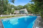 This enchanting property offers a tranquil retreat on approx. 2.33 acres in Southampton and Water Mill&rsquo;s picturesque horse country. A gated entrance welcomes you to lush, park-like grounds featuring a heated saltwater pool, a pool house, expansive patio and deck areas, and beautifully maintained gardens. Inside, you&rsquo;ll find a country kitchen, a bright sun-filled living room with double-height ceiling and a fireplace, a formal dining room, a bonus room or den, and a full basement. The unique powder room reflects a polo-inspired design. A breezeway connects to a two-car garage, while the sumptuous primary suite above boasts a private balcony overlooking the serene backyard. Don&rsquo;t miss this bucolic oasis in the Hamptons.