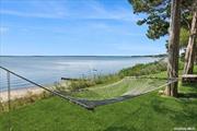 Discover a hidden gem nestled on over 2.3 acres along the stunning Peconic Bay. This unique property boasts a sandy beach and breathtaking views from most of the premises, epitomizing the charm of true North Fork living. With 5 bedrooms, 3 full bathrooms, art studio, and an open floor plan, the potential here is truly boundless. The large two-car garage features a full bathroom and additional living space above, offering even more versatility. Embrace the opportunity to transform this diamond in the rough into your dream home.