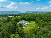 Discover the perfect blend of classic charm and modern luxury at The Garrison Estate. This exquisitely transformed 1930s Hudson Valley home was meticulously reinvented from top to bottom in 2023 and offers 6, 800 square feet of alluring living space on 12.28 acres. The center hall colonial has been painstakingly renovated to keep its traditional charm and elegance while infusing many playful and modern design elements of today. Entertain effortlessly in the expansive dining room, state-of-the-art media room, and resort-like pool area. Enjoy five private ensuite bedrooms which showcase their own unique style. Additional amenities include an EV charging station, 3 versatile accessory outbuildings, dog wash station and an original 1900s tennis observatory overlooking a court-ready site. This extraordinary estate, located on the eastern side of the Hudson River, offers a serene retreat combining luxurious living with the best of the Hudson Valley&rsquo;s natural beauty, just one hour from NYC.