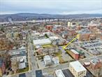 50 Academy Street, Poughkeepsie, NY 12601Price: $2, 900, 000  4-Unit Apartment Building  Redevelopment OpportunityLocated in the heart of Poughkeepsieâ€™s rapidly growing Innovation District, 50 Academy Street offers an exceptional mixed-use redevelopment opportunity. This 4-unit, 2-story, 2, 800-square-foot apartment building sits on 1.11 acres across 11 parcels, making it one of the largest assemblages available in downtown Poughkeepsie. With its strategic location, flexible zoning, and strong demand for residential rentals, this property is ideal for developers seeking to capitalize on Poughkeepsieâ€™s continued growth and revitalization.Zoning & Development PotentialThe property is zoned PID-B (Poughkeepsie Innovation District B) and MU-5 (Mixed-Use 5), offering high-density residential and commercial development potential.PID-B Zoning: Allows up to 9 stories (120 ft) with affordable housing inclusionMU-5 Zoning: Allows up to 7 stories (94 ft) with affordable housing inclusionPermitted Uses: Multifamily residential, retail, office, hospitality, medical, live-work housing, student housing, performing arts, and food serviceNo Historic Restrictions: The property is not located within a City Historic DistrictSeveral conceptual massing studies by Tinkelman Architecture demonstrate the siteâ€™s potential:Option A: 35 residential units / 26 parking spacesOption B: 55 residential units / 28 parking spacesOption C: 76 residential units / 52 parking spacesOption D: 116 residential units / 49 parking spacesThis flexibility makes it ideal for mixed-use, multifamily, or residential redevelopment.Parking & IncentivesThe site offers on-site parking design flexibility, including the potential for a Planning Board waiver or fee-in-lieu of parking. Additionally, it is adjacent to a municipal parking lot at 50 Cannon Street, providing 210+ spaces within 50 feet.The City of Poughkeepsie supports development in its Innovation District, creating potential opportunities for incentives and streamlined planning approvals.Prime Downtown LocationCentrally located, 50 Academy Street is within walking distance to:Restaurants, cafÃ©s, and boutique shopsArt centers and the historic Barrett Art CenterVassar Brothers Medical Center, a major employer in the areaThe property also offers easy access to major transportation routes, including Route 9, the Mid-Hudson Bridge, and Metro-North Railroad, connecting Poughkeepsie to New York City and surrounding Hudson Valley communities.Investment HighlightsPrime urban infill location in a growing downtown marketHigh-density development as-of-right with significant bonus potentialStrong residential rental demand in Poughkeepsieâ€™s revitalized coreFlexible mixed-use zoning for a variety of income-producing optionsThis is a rare opportunity to acquire a large, strategically located parcel with unmatched redevelopment potential in one of the Hudson Valleyâ€™s most dynamic growth markets.