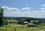 Experience the beauty of this picturesque 62-acre farm, complete with a 3-year-old, 3-bedroom, 2-bath manufactured home designed for modern comfort. The property boasts rolling hay fields, peaceful woods, a meandering stream, and varied elevations with stunning views. A popular Motocross track adds a touch of excitement and serves as a local favorite. The spacious barn offers a workshop, animal pens, and ample storage, with additional space on the second floor. Two detached garages-one with 3 bays and the other with 2-provide room for equipment and recreational vehicles. Discover endless possibilities on this exceptional property.