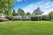 Welcome to 123 Handsome Avenue, Sayville. This quintessential Mid-Century Modern ranch truly represents the art of living with an aesthetic that is both timeless and contemporary. Built in 1955 and with inspiration from concepts developed by Frank Lloyd Wright, the open floor plan provides a spaciousness that also allows a private connection to the outdoors. Generous in size with over 2, 600 square feet of living space the home includes a living room with fireplace, formal dining room and beautiful den for private gatherings or large festive celebrations. The bedroom wing comprised of four bedrooms, includes the primary bedroom with a full en suite bath and an additional full bath in the hall. Wood floors are throughout the house. Utilities include forced hot air heating and central air-conditioning, separate hot water heater, washer and drier. The large basement has direct access from inside the house or by way of an outside entrance. The yard with many unique and special plantings provides privacy as well as room for recreational pastimes, a two car garage and plenty of space for an in-ground pool. From the embrace of the foyer, the gentleness of natural light and the extraordinary connection between indoor and outdoor space, you will be certain to always enjoy the art of living and peace of being home.