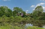 Sun-drenched, cedar contemporary merges architectural innovation and carefully curated period details. Sited on 82.5 acres that reflect Dutchess County&rsquo;s storied farming history, it&rsquo;s 90 easy miles from Manhattan and minutes to Rhinebeck and Red Hook. Has expansive views of rolling meadows and spring-fed ponds that attract all the area&rsquo;s wildlife. There are open trails through the woods and orchard for long walks or cross-country skiing. Expansive main level offers open kitchen; great room with stone fpl. and vaulted wood ceiling; and, primary suite -- all enjoy views of the ponds and the Catskills. There is also a second bedroom and 2 baths. Wraparound deck and covered porch overlooks a heated swimming pool. The second floor has a guest suite, sitting office and full bath. The pristine acreage offers options as a small agricultural or equestrian farm. Minutes to Bard College&rsquo;s Fisher Center, area farm markets, exceptional farm-to-table restaurants, and conv. to the TSP and Amtrak.