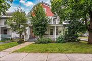 Discover this charming colonial home in the heart of Glens Falls. The entryway features a beautifully crafted staircase and elegant woodwork. The double living room, with a wood-burning fireplace and French doors, is perfect for entertaining. With 5 bedrooms and 3 baths, this home offers ample space. The kitchen boasts custom cabinetry and stainless steel appliances. The finished attic provides extra living space with 2 bedrooms, an office, and a full bath. Enjoy the expansive front porch. Conveniently close to downtown, shopping, schools, Crandall Park, and Lake George.