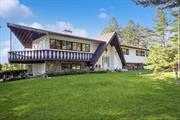 Welcome to this lovely residence, first time on the market. This expansive home was lovingly custom built, overlooking 6.22 wooded acres providing privacy, with views westward through plentiful windows to the Hudson Highlands and on to the Catskills. From the wide foyer, up a few steps to the main floor. To your left a generously sized dining room has a large stone fireplace. The walk though kitchen opens to a music room, with direct access to covered deck. From the hallway you find the laundry, primary suite, and 2nd and 3rd bedrooms, and hall bath. The lower level features water statuary, flanking a wet bar and family room, also with fireplace. Generous storage follows the wall behind. A 4th bedroom plus office/study on one side, and sunny conservatory opens onto wrap around patio complete with hammock hookup. The large, private backyard has raised garden beds, large storage shed and a whimsical hobbit house feature. Truly a an elegant oasis in which to write your own story. Appliances: Electric Water Heater Flooring: Carpet, Ceramic Tile,  FoundationDetails: Slab,  InteriorFeatures: Built-in Features,