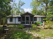 Quaint, cool, cozy, and unique are the best ways to describe this 1920&rsquo;s 1 bedroom bungalow on over 3/4 of an acre. This summer getaway has so much to offer with its unique character and many features such as fire pit, large shed, arbor and more. Property goes all the way over to Poplar. Walk through the wooden gate, through the arbor to the walking path to the cottage. Follow the garden path to the main house. Large stone patio for entertaining is located right outside a screened in porch Property fronts two roads. HOME WAS FEATURED IN METROPOLITAN HOME MAGAZINE 1992. Have to see it for yourself to appreciate the character and charm.