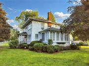 Step into the charm and character of this classic 1915 two-story home located in one of Kingston&rsquo;s most desirable neighborhoods. This beautifully maintained residence offers three bedrooms and one and a half baths, making it a perfect full-time home or a weekend retreat. Less than two hours from New York City, this home provides a peaceful escape with the convenience of walking distance to the bus station and Kingston&rsquo;s vibrant uptown historic district, filled with upscale restaurants, boutiques, and entertainment. The interior of the home radiates elegance, starting with the spacious living room, where tall windows flood the space with natural light. The room&rsquo;s rich hardwood floors and the classic brick fireplace create a warm, welcoming ambiance. Adjacent to the living room, the formal dining room features arched doorways and windows, with a beautiful chandelier enhancing the space&rsquo;s timeless appeal. Upstairs, the bedrooms are bright and spacious, with large windows that allow the sunlight to pour in, creating tranquil spaces to relax and unwind. Each room retains the home&rsquo;s historic character, with lovely wood trim and original details. The sunroom offers a cozy spot to enjoy your morning coffee or relax in the afternoon, with large windows providing serene views of the manicured grounds and neighborhood. The vintage kitchen provides a functional space filled with original cabinetry, perfect for those who appreciate the home&rsquo;s period charm while offering potential for modern updates. Outside, the home sits on a well-maintained corner lot, complete with a detached two-car garage. The lush green surroundings offer plenty of room for outdoor entertaining or peaceful afternoons spent in the garden. This property&rsquo;s prime location offers the best of both worlds: a peaceful residential setting within walking distance to Kingston&rsquo;s bustling uptown district. With easy access to the bus station, it&rsquo;s an ideal spot for those who want to enjoy the tranquility of the Hudson Valley while remaining connected to New York City. Whether you&rsquo;re looking for a primary residence or a charming weekend home, 219 Washington Avenue offers a unique opportunity to experience the historic beauty and vibrant lifestyle of Kingston.