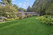 True Mid-Century Modern custom-built home modeled in the style of Frank Lloyd Wright Prairie homes architecture. This residence is located on a quiet tree-lined country street. This shy-acre property features mature landscaping with specimen plantings, rock gardens, and spacious back property with room for a pool. Upper level of this beautiful residence features a bright and airy floorplan with floor-to-ceiling windows in the living room with a three-sided fireplace dividing the living room and dining room. These rooms open to a cozy den with a 2nd fireplace and wraparound windows. The eat-in kitchen has stainless-steel appliances, stone countertops and backsplash, and a lovely breakfast area. The master suite boasts ample closet space, a private home office and a luxurious bathroom with free-standing tub, dual vanities, and huge shower. The other upper-level bedroom is spacious with a 2nd hall bath with dual vanities and shower. All bathrooms are appointed with tasteful nickel fixtures and fittings. The expansive lower level features a large den with floor-to-ceiling windows, a separate walk-out entrance, original light fixtures, and an original Mid-Century bar with a bar dishwasher and refrigerator, perfect for entertaining and drinks. Lower level also has a large media room, an additional 2 bedrooms, and a 3rd full bath with a shower and stone counter vanity. Outdoors offers a generous patio with verdant views.  Highlights include gleaming hardwood floors, central air-conditioning and attic fan, 2-zone heating, a 2-car garage, a small barn/shed, and original Mid-Century lighting fixtures throughout that were installed when the home was built. Close to historic Huntington Village, shopping, dining and just minutes to CSH train station and local beaches.  This is a very special property for the discerning buyer who wants original Mid-Century design and living/entertaining at its finest.