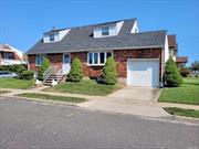 True Wide Line Cape on a 60 X 100 lot. Home needs a little updating but has great bones and large rooms. Great outdoor space with 2 driveways, one on each side of the home an a attached garage. Home features 4 doors to outside. Finished basement with Full Bath, Summer Kitchen and Separate Outside Entrance. Updated Heating System and Gas Hot Water Heater. You do not want to miss out on this home.