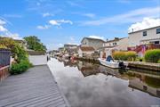 Experience Affordable Waterfront Living in this Charming Ranch-syle Home located in the Village of Lindenhurst featuring 3 Large Bedrooms and 1 Full Bathroom. This home has a remarkably roomy interior, offering nearly 1, 300 square feet of living space.Step inside to find Beautiful Hardwood Floors that flow seamlessly throughout the Spacious Rooms, an Open-Concept Layout, and Elevated Ceilings that draw your attention to the Stunning Kitchen. The Expansive Kitchen showcases Striking Red Cabinetry highlighted by a Beautiful Glass Italian Backsplash, a Large Center Island with Black Cabinets, Stainless Steel Appliances, and Sleek Granite Countertops. Enjoy stunning Canal Views from the Large Outdoor Deck, accessible through two different sets of Sliding Doors. Additional features include Gas Heat, New Roof (2022), 37.5 feet of Dock Space, Fully Fenced Backyard, Large Bedrooms (each approx 14 x 16), LOW TAXES! Close proximity to Restaurants, Shopping, Parks, Beaches, Tanner Park, LIRR and minutes to the Great South Bay. Move-in ready. This home is a perfect retreat for boaters and outdoor enthusiasts! Don&rsquo;t miss this opportunity to call this HOME!