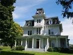 Discover the historic charm of 14 Linden Farm Lane, a stately mansion built in 1875. This grand and gracious residence offers a unique opportunity for its next generation to update and modernize; unlocking its full potential. The home&rsquo;s Second Empire architecture greets you from the moment you arrive, with a tree-lined drive leading to its signature mansard roof and intricate bracketed cornices. A central rectangular tower adds to the distinguished exterior, recalling the sophistication of its era. Step through the original double front doors into living spaces flooded with natural light, thanks to oversized windows that frame stunning views of surrounding farmland. Period details abound, including intricate moldings, hardwood floors, marble fireplaces, and French doors, all of which are well-preserved. The kitchen and two full bathrooms, while fully functional, are ready for updates to make this extraordinary period home contemporary. A grand staircase leads to the second floor, where three bedrooms offer comfortable, spacious retreats. Here, too, natural light flows through large windows. There&rsquo;s a reading nook on the landing and even the wide corridor offers a spot to sit and enjoy the view. The third story, an untouched time capsule from the late 19th century, features five bedrooms with original wallpaper, period lighting fixtures, and marble sinks in each room. This level has never been renovated, presenting a rare opportunity for restoration enthusiasts to preserve or modernize as desired. A staircase leading to the cupola with 360-degree views tops it all off. Outside, a wrap-around porch envelops the home on three sides, providing a tranquil space to take in the views of the expansive grounds and farmlands beyond. 14 Linden Farm Lane is a remarkable piece of history, blending historic elegance with endless potential. With a little care and creativity, this home could be transformed into a masterpiece that preserves the best of its past while embracing modern living. Additional Information: HeatingFuel:Oil Above Ground, Appliances: Electric Water Heater ConstructionDescription: Wood Siding,