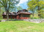 Discover unparalleled tranquility in this fully furnished contemporary craftsman style home on 24 private acres. With 4 bedrooms and 3 full baths, this contemporary gem features a sunken living room with a stone fireplace and expansive windows. The open-concept kitchen offers abundant light, while French doors in the dining area lead to a screened-in porch with picturesque views of a spring-fed pond, meandering stone walls, and expansive manicured grounds. Nestled within the Shawangunk Mountains, this estate provides exclusive hiking access to the Awosting Reserve. Enjoy ultimate privacy and breathtaking nature conveniently from your front door. Perfect for a peaceful city escape or a weekend retreat. Seize this rare opportunity at a remarkable value, listed below market!