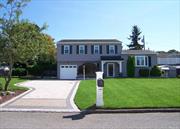 Welcome to this Elegant colonial, featuring 4 Bedrooms and 2.5 Bathrooms. Gleaming Hardwood Floors throughout. Tiled entrance Foyer. Sunlit, new renovated Eat-in-Kitchen with Quartz countertops. Cafe Series Appliances, undermount cabinet lighting. Spacious formal Living Room and Dining Room featuring custom plantation Blinds. Tiled Family Room with Anderson Patio French Doors, opening up to a meticulously manicured backyard oasis with Patio Pavers. Hot tub & Electric outdoor awning to keep you cool from summertime heat.