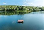 This is Hudson Valley lakefront living on gorgeous and private Upton Lake. The waterfront retreat has 43 feet of frontage on the 46 acre, spring fed, 55 foot deep glacial lake in Clinton Corners, NY. Year long tranquil and picturesque experiences await you here with an abundance of recreation, relaxation, and nature. Thoughtful decking and mature landscaping leads down to the lake, where you access it from the waterfront dock or a floating one nearby. Simply stunning. The decking includes a hot tub + outdoor shower. Entering the home you arrive in a three season, charming screened or windowed front porch. This level includes open kitchen/dining w/ sliders to lakeside decking, small office, laundry and full bath. The upper level includes wall of windowed primary bedroom with cathedral ceiling and ensuite bath. Two other bedrooms are also here. The lower level is living space/den with herringbone flooring, more glass sliders leading to the lakefront magic. A workshop and mechanicals are also on this level. Convenient to the Taconic State Parkway, this is all just 2 hours from NYC. Welcome to the Hudson Valley. Additional Information: Amenities:Pedestal Sink, Stall Shower, Storage, ParkingFeatures: On Street,