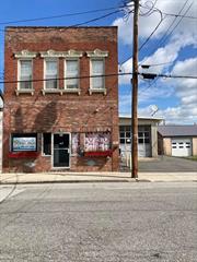 Earn 12% return on investment or a lot more. Great Historic brick building on Front Street in the Renaissance City of Port Jervis. This Huge 3500 square foot building is Active Business downstairs and two modern residential apartments upstairs. Walk to NYC Trains. Would be Great as an Air B&B which would bring the CASH in hand over fist. As is now Business pays $2200 per month and apt bring in $2700 for $4900 gross oer month of $58, 000 gross per year. Net return on Income is $48, 000 per year as tenants pay water sewer and utilities.