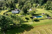 Exquisitely restored 1822 farmhouse on 20+ acres in Millbrook, NY, blending historic charm and modern luxury. This stunning home features sun-filled rooms, original hardwood floors, and six fireplaces. The gourmet kitchen is equipped with marble countertops, high-end appliances, a butler&rsquo;s pantry, and a fireplace. A beautiful sunroom with floor-to-ceiling windows and marble floors connects seamlessly to the outdoors. Additional highlights include a powder room, mudroom, and library with an en-suite bath. The upstairs primary suite boasts a private porch, fireplace, walk-in closet, and a luxurious bath with a brass soaking tub and marble shower. Three additional bedrooms, all with en-suite baths, offer flexible living spaces. The meticulously landscaped grounds feature a serene gunite pool with breathtaking views. Completing the estate is a three-car garage. A rare opportunity to own a historic Millbrook treasure. 2 lots equaling 20.83 acres. Taxes reflect both lots.