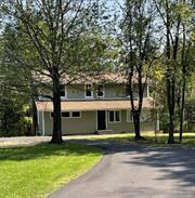 Welcome to this renovated 1924 Colonial gem, nestled on 1.39 acres down a private road in the charming hamlet of Stone Ridge. Step into the heart of the home a galley kitchen featuring brand-new countertops and cabinets, perfect for culinary creations. With a full bathroom added on the first floor, convenience is at your fingertips. Imagine cozying up by the inviting working fireplace in the living room as the cool fall air settles in, creating the perfect atmosphere for relaxation and warmth. Significant upgrades throughout the home include 12 newly replaced windows, enhanced insulation, and fresh siding, ensuring both comfort and efficiency. The living room opens onto a spacious deck, an ideal spot to unwind and take in the seasonal views as the leaves change. Venture upstairs to discover two comfortable bedrooms, a newly renovated bathroom, and a versatile small room with a window that could serve as a cozy office or additional storage space. The walkout basement offers utility access, UV light, and washer and dryer hookups for added convenience. Situated just moments from scenic bike and rail trails, the stunning Mohonk Mountain, historic Kingston, and major shopping areas, this home offers privacy and accessibility