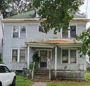 This charming two-story house, built in 1900, exudes 20th-century character and elegance. Featuring four spacious bedrooms, it offers a welcoming kitchen, a cozy living room, a stylish dining room, and a family room, all adorned with beautiful hardwood floors and crown molding with a full unfinished basement this presents an exciting opportunity for renovation, allowing you to restore the space to its historic classic beauty. With its timeless charm and potential for modernization, this home is perfect for those looking to blend history with contemporary living at a great price.