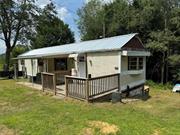 Newly renovated 2023, move in ready. Experience country living in this mobile home. Open concept kitchen, dining and living area with windows inviting natural light to fill the space, creating a warm and inviting atmosphere, two bedrooms, laundry area and one full bathroom. A storage shed or garage for a small car. The basement is unfinished would make a great workshop or studio. The property is located within walking distance to the charming town of Hurleyville. Hurleyville is a thriving hamlet with plenty of shops, eateries, arts and entertainment to offer. A friendly, quaint hamlet in the town of Fallsburg located in the majestic Catskill Mountains in Sullivan County!