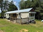 Newly renovated 2023, move in ready. Experience country living in this mobile home. Open concept kitchen, dining and living area with windows inviting natural light to fill the space, creating a warm and inviting atmosphere, two bedrooms, laundry area and one full bathroom. A storage shed or garage for a small car. The basement is unfinished would make a great workshop or studio. The property is located within walking distance to the charming town of Hurleyville. Hurleyville is a thriving hamlet with plenty of shops, eateries, arts and entertainment to offer. A friendly, quaint hamlet in the town of Fallsburg located in the majestic Catskill Mountains in Sullivan County! Additional Information: HeatingFuel:Oil Above Ground,