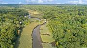 Welcome to your future home on the Nissequogue River in beautiful Smithtown! No need to ever leave when you can experience the Fall foliage from every window, with stunning unobstructed panoramic views of the river and protected wetlands and nature preserve......This private and incredible property sits directly on a gorgeous and stately setting with direct river access right from your own backyard for fishing, kayaking and canoeing!! Quiet and, serene, this bird lover&rsquo;s paradise offers not just a home, but a lifestyle perfect for nature lovers and outdoor enthusiasts. Just shy an acre, minutes from the center of town and close to all, this super convenient location offers panoramic views which are the main focus for this ranch style home. Entertaining outdoors is easy with the new large exterior decking just perfect for gatherings and parties ! Expansive slate patio below also overlooks the stunning river views and runs the length of the house.... enjoy lounging on lazy afternoons in a glorious setting most dream about! As soon as you enter this gorgeous home with breathtaking setting, you are welcomed with a wall of windows overlooking this unique property. Huge master bedroom has en-suite bath and 2 closets overlooking the beautiful views and two additional bedrooms and another full bath on entry level. Large EIK is loaded with charm and character, with a brick wall, oak cabinets, built ins and a super nice cozy space.....Bring your telescope to enjoy the bright and beautiful sun drenched room with wrap around windows and skylight...... watch the nature surrounding you in this glorious sunroom just next to the kitchen and across from spacious laundry room and oversized 2 car garage. Additional nice features include new wood floors. IGS and security system, Generac generator provides immediate power backup. Lower level encompasses 35 ft long additional den w/large windows overlooking the river, built in stereo and record player w/in-wall speakers and sound system wired throughout entire home, automatic power outdoor vertical shutters and brick fireplace recently converted to gas. There is also another full bath and a large office on lower ground level which can convert to 4th bedroom, plus a playroom/craft room with built-in storage. Additional storage room. Extensive brick and slate work on entire property. Home has been lovingly maintained by one owner, now make it your own!!!