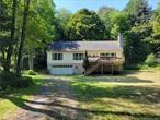 This 3-bedroom, 2-bath home offers deeded rights to the Tannery Woods lakefront beach on Swinging Bridge Reservoir, providing you with exclusive access to this 9 mile motorized lake. Nestled on 5.6 acres of park-like land, the property boasts a long driveway that ensures privacy. The home spans 2, 352 square feet and features a master bedroom, spacious rooms throughout, and both front and back decks perfect for outdoor relaxation. The partially finished basement and walk-up attic offer additional living space potential, making this home versatile.Amenities include a 2-car attached garage, a washer and dryer, and a cozy woodburning fireplace. Close to Bethel Woods (Original Woodstock Festival Site). Catskill Resorts Casino, Swinging Bridge Reservoir, shopping and restaurants. Additional Information: Amenities:Storage, HeatingFuel:Oil Above Ground, ParkingFeatures:2 Car Attached,