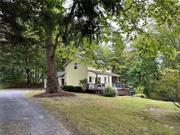 Location, location, location. This charming River Rd. Cottage is nestled along Rhinebeck&rsquo;s most prestigious and picturesque roads. Built in 1910 as an Astor tenant house, with a long tree-lined driveway, is a true gem. This private 1.2-acre lot has southern exposure featuring two bedrooms and two full baths, a perfect getaway with unlimited potential. The convenient location and vintage structure are a blank canvas for transformation and elevated value. Creating a rare opportunity for the right buyer. Enjoy the wood deck with a pergola for ultimate relaxation. Walk through the charming vintage living room with gorgeous original wide plank wood floors. Then step into your lovely screened-in porch, elevated and built in all wood for a truly rustic feel. The classic country kitchen features high ceilings with wood beam detail, original cabinetry, and tile floors. Enter the large bathroom with a built-in tub and a classic dressing table-style vanity. The primary bedroom has vaulted ceilings and stunning views of the forest, with a walk-in closet and outdoor entrance adding privacy and convenience. The upstairs includes a second bedroom and sitting room or office. The second bathroom is equipped with a stand-up shower, and tons of natural light from the skylight above. A sweet and classic cottage in the heart of Rhinebeck, less than 2 miles to Rhinebeck village and the Rhinecliff Amtrack train stain.