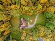 Welcome to this enchanting log cabin in Millbrook, NY, built in 1989 and nestled on over 3 acres of picturesque land. As you enter, you&rsquo;re greeted by an inviting open-concept layout that seamlessly connects the kitchen, living room, and dining area perfect for entertaining or cozy family gatherings. The stunning two-story brick fireplace serves as a focal point, adding warmth and character to the heart of the home. The primary bedroom features its own private bath, ensuring a tranquil retreat, while two additional bedrooms provide ample space for family or guests. A full bath and a convenient powder room enhance functionality. Outdoor enthusiasts will appreciate the expansive grounds, ideal for exploring or unwinding. The property includes a two-car attached garage, a large workshop for hobbies or projects, and generous basement storage. Experience the perfect blend of rustic charm and modern convenience in this delightful Millbrook cabin. Call us today, will not last!