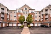 Experience luxury living in this corner unit at the premier 55+ community in Fishkill, NY. Former model home, built with top-of-the-line upgrades, features open-concept layout with 9 ft ceilings, tray ceilings in entry foyer, wide plank hardwood floors, plantation shutters throughout the kitchen and primary suite. Chef&rsquo;s kitchen boasts granite countertops, stainless steel appliances, movable marble island, and formal dining area. The primary suite with en suite bathroom has a dual-sink granite vanity, Roman soaking tub, glass shower, custom high end wall moldings and walk-in closet with custom built-ins. Second bedroom has textured wallpaper and wainscotting, an upgraded hallway bathroom with Shower/tub and granite vanity. Custom floor-to-ceiling Built-Ins located in the living room and Office. In-unit laundry, Private patio, and private garage spot in front of the building. Access to a private clubhouse, fitness center and pool.