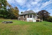 Unique Turn-of-the Century home with character and history is on the outskirts of town with easy access to all services. Built in 1900 much of the charm and original woodwork is still intact. Features include wood floors throughout, large living room with a built-in window seat, wood-burning fireplace (needs work), high ceilings (10+/- ft), and a huge expansive front porch with walls of windows (400+/- SF) for additional living space. The interior boasts oversized windows which allow maximum natural light through the home. Eat in kitchen offers newer refrigerator and washer and dryer hook-up. Dining room and mud room are a plus. Home is situated on a country road with a lovely yard on a corner lot in a quiet area. Pull down stand-up attic has room for seasonal storage with cedar closet. Needs a little elbow grease and is worth the effort to have a comfortable year-round abode or a weekend getaway in the Sullivan County Catskills at a discount. Priced to sell so hurry!