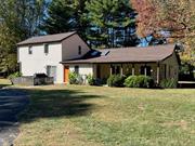 Whimsical Circa 1940 Country Cottage with 2 story addition built in 1987. Brand new roof 10/2024! Set down a long driveway on 1.6 magnificent park-like acres with sprawling lawns and glorious ancient shade trees. Enter this sweet home into large mud room to hang your hat and remove those muddy boots! The bright, cheerful kitchen is the hub of the home with vaulted ceilings and skylights and is open to large dining area and spacious living area with corner propane stove for a cozy fire on those chilly nights. Also on the main level on the opposite side of living area you will find a generous sized guest bedroom with separate entrance perfect for mother, plus a den/office/4th bedroom and a full bath. Lovely sunroom off the living area looks out at the beautiful backyard to watch the little ones run and play. Upstairs features a super spacious primary bedroom with soaring ceiling and skylights, full bath plus another bedroom. Oversized 2 car garage with plenty of space for workshop, artist studio or hobbies. The location can&rsquo;t be beat within walking distance to movie theater, shopping, restaurants, ice cream, and about a 10 minute stroll to the charming village of Red Hook. It&rsquo;s now time for new owners to make this sweet gem their own and love it,  just as the current owners have for decades. Appointment only.