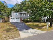 Bring your decorating ideas and make this house your home! This 3 bedroom, 2.5 bath colonial is located in a beautiful neighborhood within the Middle Country School District and is waiting for its new owner. Can easily be converted to 4 bedrooms upstairs. Hardwood floors exist throughout the second and third floors. There is a wood-burning fireplace in the den. The oversized primary bedroom has an ensuite bathroom. 2 car garage with opener. Outside you will find a large backyard with mature trees. This home is conveniently located near shopping, restaurants, and schools. Original owner(s).