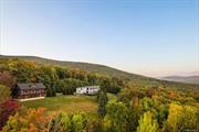 Welcome to Vly Mountain Retreat, an exquisite estate in Lexington upstate New York&rsquo;s best-kept secret. With uninterrupted views of the Catskill Mountains, modern comfort is seamlessly balanced with the raw beauty of the surrounding wilderness. Set on 9 park-like acres, this compound includes a 3BR, 3.5BA main house and a 3BR, 3BA carriage house. Designed for comfort, convivial gatherings, and peaceful seclusion, both buildings capture breathtaking views of pristine wilderness and mountain peaks, with a seamless flow between indoor and outdoor spaces. The main house features a spacious open-concept living room with floor-to-ceiling windows on three sides, flooding the space with natural light and uninterrupted views. Motorized shades provide control over privacy and ambiance. A minimalist, striking wood-burning fireplace anchors the living area, which flows into a state-of-the-art chef&rsquo;s kitchen with a gas range, large island, and ample storage. Luxurious bathrooms are equipped with spa showers, high-end fixtures, and elegant tile work. Some baths feature deep soaking tubs and walk-in showers, blending relaxation and convenience. Wellness amenities include a fully-equipped gym with stunning views, an oversized steam room, and an infrared sauna. Outdoors, a bespoke masonry staircase leads to an in-ground saltwater pool a serene summer oasis. A stone firepit is perfect for evening gatherings. The low-maintenance grounds are dotted with trees and feature 1, 400 square feet of decks and balconies offering multiple scenic vantage points. The carriage house, with its bracketed, overextended roof and clapboard and stone exterior, nods to heritage design. These guest quarters include three bedrooms with en-suite baths, mountain views, and wraparound balcony access. The 3-car garage with 10 ft clearance provides flexible storage, and a bonus room offers space for a home office or leisure. This gated compound includes two 16kW standby generators, a new septic system, deep well, central HVAC, Nest thermostats, and Gigabit fiber. Located 2.5 hours from NYC and just 20 minutes from Hunter Mountain and 25mins to Belleayre + Windham. This estate harmonizes luxury and nature, perfect for both escapes and gatherings.