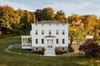 Introducing The Mayorâ€™s House. Built in 1836 by Oliver Wiswall, this stately Greek Revival home sits perched upon a hillside just outside of Hudson, NY in the coveted Mt Merino neighborhood with legendary views up the Hudson River. Pulling into the tree lined driveway and turning to the West, itâ€™s easy to see why this area inspired a generation of artists known as the Hudson River School of Painters, the first native school of painting in the United States. The solid brick home retains the grand feeling of its original prominence with dentil moldings, Doric & Ionic order columns and three stories of living space plus a full basement. The main floor boast high ceilings, beautiful restored moldings, 2 front sitting rooms with fireplaces and a large dining room. A striking 1980â€™s addition is connected to the rear of the house with a 20+ foot vaulted ceiling and features a modern kitchen, pantry area with laundry, casual dining, sitting area, and access to a stone patio to enjoy the jaw dropping views. Upstairs find a primary ensuite, additional bed and ensuite bath. A third floor provides two additional bedrooms, a third full bath and den. Wood floors, big windows, tons of natural light and views throughout. A recent renovation includes all new heating and cooling, new roof, new septic tank, new kitchen and baths, new landscaping and driveway, new fixtures and finishes. The property is just under 40 acres of open lawn surrounding the home and woods in the back. Located under 2 miles to Warren Street in Hudson, convenient to the Rip Van Winkle Bridge, Amtrak Train, Olana and many of the Hudson Valleyâ€™s most popular destinations. Additional Information: ParkingFeatures:2 Car Detached,