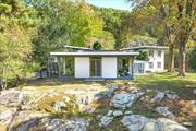 Mid-Century Modernist home privately nestled on 4 secluded beautiful acres close to NYC/Metro N, shops, hiking trails, & watershed. This unique 3500 sq ft 4BR/3.1 Bth features versatile living spaces designed around stunning stone outcroppings, sunset views, serene gardens, & towering trees. Modernist open floor plan, high ceilings, multiple terrace & garden areas, large windows, & abundant natural light thru-out. The custom design offers a 600 sq ft, light-filled Great Rm w floor-to-ceiling glass & FPL, a 1-level pavilion connected to 2 add&rsquo;l 2-story buildings by 16&rsquo; high passageways, a brick patio, glass walls, & slate flrs. Suits diverse lifestyles: home-office suite w sep entry, guest suite, or sep work/artist studio. Renov EIK w SS appliances, wood cabinetry, & island opens to a DR/FPL, stone & glass Sunrm w pond & formal garden views. 3 separate flrs feature unique BR suites w/renov baths. Located atop a winding drive in a stunning natural setting. A gem not to be missed.