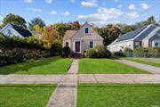 This three-bedroom brick home is situated in the Malverne school district. It features a large backyard, newly painted laminate flooring, and a large driveway.