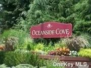 Welcome to resort living in the desirable Oceanside Cove!!! This spacious one bedroom, one bath, lower unit with private patio boasts many updates.... Open concept, granite and stainless kitchen, updated bathroom, oversize primary bedroom with generous closet, Great size living room and dining area, sliders to the patio, washer/dryer, professionally landscaped, 3 pools, clubhouse, library, party room, fitness center, sauna, basketball and tennis courts, playgrounds, Bocce /shuffleboard, and designated dog run, close proximity to the beach, 24/7 gated security, assigned parking and ample guest parking available