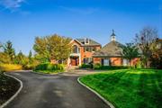 Welcome to 18 Kingwood Lane, a private cul-de-sac residence in the prestigious Spackenkill area, Kingwood Park, just a train ride away from New York City. This elegant red-brick Georgian Colonial spans over 5, 300 sq. ft., offering a seamless blend of sophistication and comfort. Arriving at the home, you are greeted by a Belgian block-lined driveway and meticulously landscaped grounds. The custom Mahogany front door opens into a grand two-story foyer, flowing into a traditional study featuring custom-built shelves and a marble fireplace. The light-filled great room, with its 10-foot ceilings, fireplace, and wet bar, offers multiple French doors leading to a blue stone terrace with breathtaking views of the Hudson Valley. Perfect for relaxation or entertaining, this space is ideal for unwinding. The spacious kitchen leads into a formal dining room framed by a hand-painted Hudson Valley mural. The main level is complete with a powder room and a slate-floor mudroom, offering side deck access for outdoor grilling and entertainment. Upstairs, the primary suite exudes luxury with custom moldings, a tray ceiling, his-and-hers walk-in closets, and a lavish en-suite bath with radiant-heated floors, soaking tub, steam shower, and linen closet. The fully finished lower level features 10+ foot ceilings, a den, gym or second office, a full bath, kitchenette, second laundry room, and living area, making it an ideal in-law or nanny suite. Multiple French doors lead outside to a resort-style outdoor space featuring a 20x40 gunite pool, overflowing spa, blue stone patio, stone walls, and a covered al fresco dining area an entertainer&rsquo;s dream. Modern conveniences include a whole-house generator, new High efficiency propane boiler, Carrier heat pumps , Sonos sound system, irrigation system, and an EV charger. The home includes a two-car garage with room for expansion to a three-car setup, and an adjacent vacant lot is available for purchase, offering the possibility of more privacy or creating a future compound. Excellent location, minutes to multiple championship golf courses, Route 9, Oakwood Friends School, Vassar Hospital, Poughkeepsie Train Station, Marist & Vassar Colleges, downtown Poughkeepsie, the Walkway over the Hudson, culinary grade restaurants, shopping & more! This home is a true masterpiece, combining all things luxury & charm in the heart of the Hudson Valley!