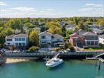 This remarkable waterfront residence in South Merrick seamlessly combines timeless charm with modern innovation. Featuring 4 bedrooms and 4 bathrooms, the home was originally built in 1960 and thoughtfully expanded in 1997 with the addition of an impressive top-floor primary suite and study. A 2011 renovation elevated the property, adding a state-of-the-art exercise room, indoor resistance pool, and spa-like hot tub. High ceilings throughout create a sense of openness and grandeur. Situated on a coveted waterfront lot with direct access to the South Shore bays and ocean, this property is perfect for boating enthusiasts and anyone seeking serene, expansive water views. The home features two-zone central air, a fully electric kitchen, and modern gas-powered amenities, including a water heater and backup generator. The outdoor space has been meticulously enhanced, providing an inviting setting for waterfront dining and relaxation. Located within the highly regarded Bellmore-Merrick School District, and close to Jones Beach State Park and Theater, as well as local marinas, and recreational activities, this home offers an unparalleled lifestyle of comfort, wellness, and sophistication