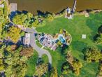 This Stunning Waterfront Estate Offers An Unparalleled Blend Of Luxury And Nature On 4.3 Acres Along Champlin Creek. With 530 Feet Of Pristine Waterfront, The Home Features Charming Cedar Shake Roofing And A Grand Two-Story Entry. Inside, You&rsquo;ll Find Wide Plank Wood Floors And Custom Finishes That Enhance The Open Floor Plan, Which Includes A Barn-Style Family Room/Bar With A Cozy River Stone Fireplace. The Custom Kitchen Is Equipped With Stainless Steel Appliances, Perfect For Culinary Enthusiasts. Outdoors, The Property Is An Entertainer&rsquo;s Dream, Boasting An Expansive Cedar Deck, An In-Ground Pool With A Hot Tub And Swim Spa, Pergolas For Shade, A BBQ Station For Al Fresco Dining, A Halfpipe, And More. Additional Highlights Include A Boat Cut-In With A Lift And A Spacious 7-Car Detached Garage. This Estate Truly Combines Elegance With A Serene Waterfront Lifestyle. The Property Also Includes A 2.43-Acre Buildable Lot.