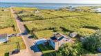 Elevate your lifestyle with this captivating waterfront retreat at 42 Cranberry Drive in Mastic Beach. Built in 1945 and thoughtfully updated within the last five years, this charming beach bungalow showcases the perfect blend of rustic charm and modern comfort. Immerse yourself in the picturesque setting with stunning panoramic views from the expansive two-level deck, ideal for sunset gatherings or tranquil mornings with nature. The home is elevated 12 feet ensuring peace of mind against the elements. Enjoy the classic cedar shake exterior, beautifully accented by new windows and doors. Inside, you&rsquo;ll find a professionally designed, seamless beach-themed interior with hardwood floors and all-new appliances inviting you into a space that feels both fresh and timeless. Additional amenities include a full-size basement, delightful outdoor shower, and a spacious shed. The property is nestled within the serene beauty of a sea grass sanctuary preserve, offering privacy and a connection to nature that&rsquo;s rarely found. With low taxes and minimal maintenance, along with proximity to Fire Island, the Hamptons, and major highways, this is a rare chance to own a piece of coastal heaven.